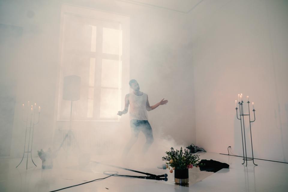 artist dancing in fog