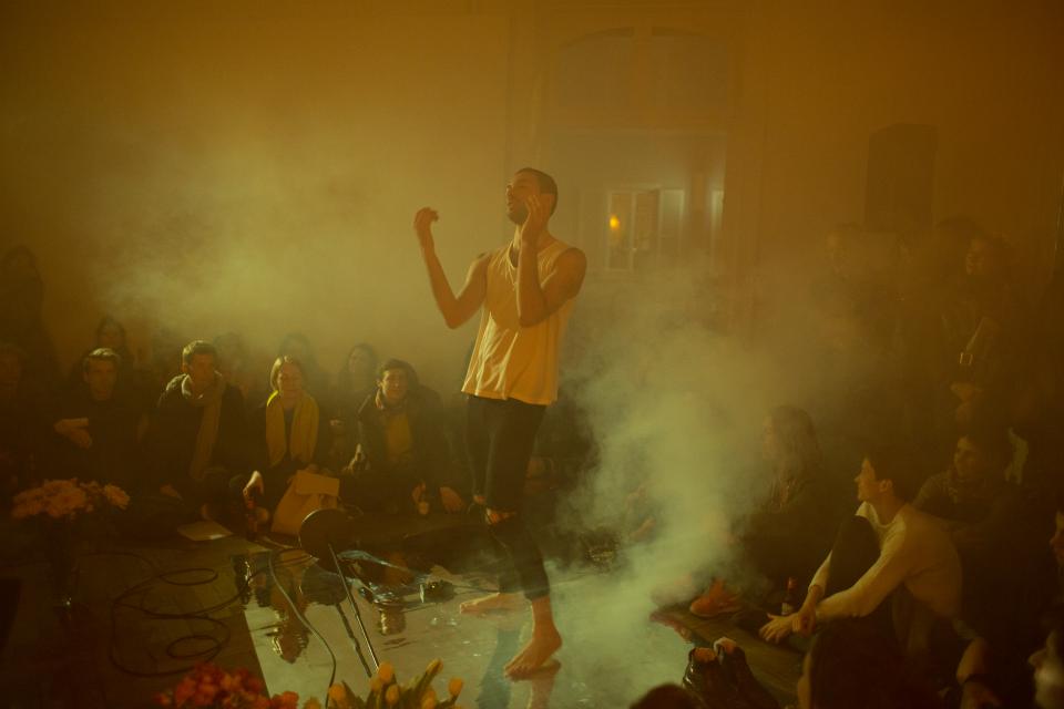 performer dancing in smoke, with audience