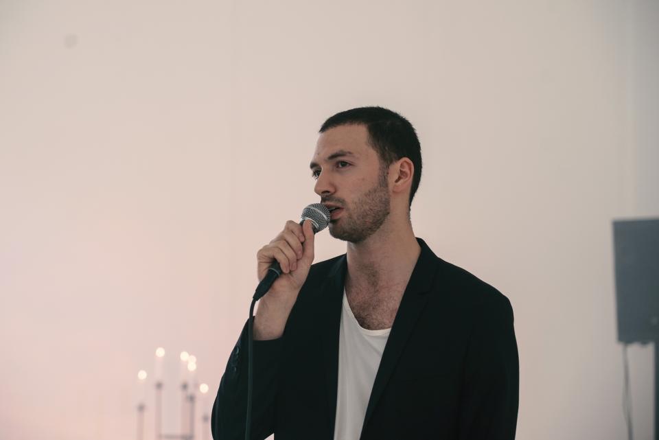 artist speaking into microphone