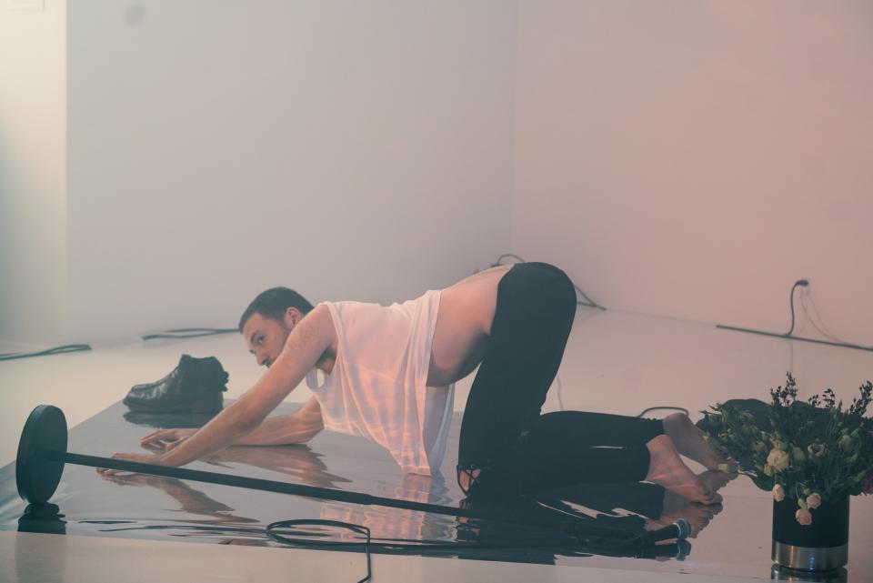 artist on knees and bending over on floor